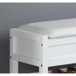 White storage bench with padded seat and shoe shelf in entryway