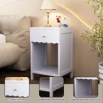 Modern nightstand with scalloped edge drawer and open shelf in lilac color, placed beside a bed