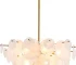 Vintage gold chandelier hanging over a dining table with warm glow