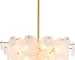 Vintage gold chandelier hanging over a dining table with warm glow