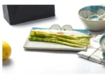 Japanese ceramic dinnerware set with hand-drawn cat design on blue rectangular plate and bowl