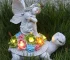 Solar angel statue glowing in garden at night