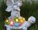 Solar angel statue glowing in garden at night