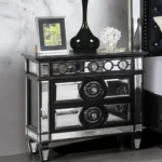 Black mirrored nightstand with 2 drawers sitting beside a bed in a glam luxury bedroom, featuring a glossy wood finish and reflective mirrored accents.