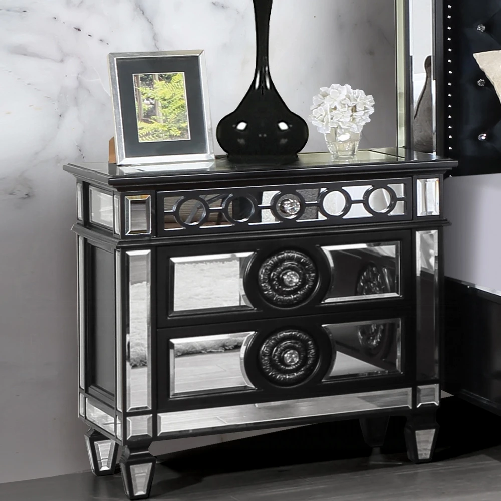 He560d3c3f72441469f6fa819801c40afC.webp Black mirrored nightstand with 2 drawers sitting beside a bed in a glam luxury bedroom, featuring a glossy wood finish and reflective mirrored accents.