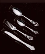 24-piece stainless steel cutlery set with gold handles displayed on a wooden table