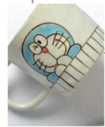 Japanese ceramic dinnerware set with hand-drawn cat design on blue rectangular plate and bowl