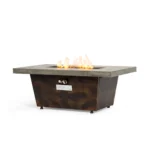 Modern metal propane fire pit on patio with glowing flames