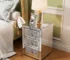 Modern crystal nightstand with drawers featuring mirrored finish and diamond details in a glamorous bedroom setting