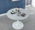 White round dining table with tulip pedestal in modern dining room
