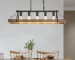 Black walnut pendant light hanging over a dining table in a modern farmhouse interior