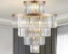 Modern gold crystal chandelier with 15 adjustable lights hanging in a living room