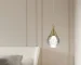 Brass globe pendant light illuminating a modern kitchen island