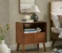 Mid century nightstand with fluted front and charging station in a bedroom setting