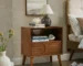 Mid century nightstand with fluted front and charging station in a bedroom setting