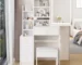 Small vanity mirror with LED lights on a white vanity table with stool and sliding storage