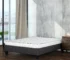 queen size mattress box in a room with white bedding
