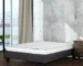 queen size mattress box in a room with white bedding