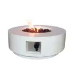 30-inch round propane fire pit table in grey color on a patio with cushions