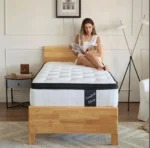 Goldoma 12-inch hybrid queen mattress with memory foam and pocketed coils in medium firmness, displayed on a bed frame
