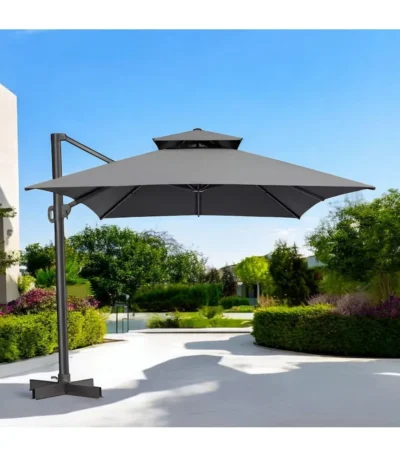 Dark gray rectangular tilt cantilever patio umbrella with stand in outdoor setting
