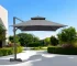 Dark gray rectangular tilt cantilever patio umbrella with stand in outdoor setting