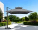 Dark gray rectangular tilt cantilever patio umbrella with stand in outdoor setting