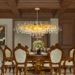 Modern crystal chandelier with brass and black finish illuminating a living room