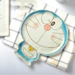 Japanese ceramic dinnerware set with hand-drawn cat design on blue rectangular plate and bowl