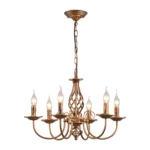 Six-light pendant chandelier in a farmhouse entryway, hanging from a high ceiling, with natural light streaming through