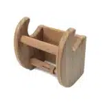 HMS toilet paper holder with a magazine resting on the lower shelf, set in a modern bathroom with white tiles.