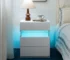 White 3 drawer nightstand with LED lighting in a modern bedroom