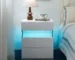 White 3 drawer nightstand with LED lighting in a modern bedroom