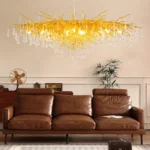 Modern crystal chandelier with brass and black finish illuminating a living room