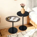 Set of two small round side tables with concentric circle walnut wood tops and black metal pedestal bases, modern design for living room or bedroom