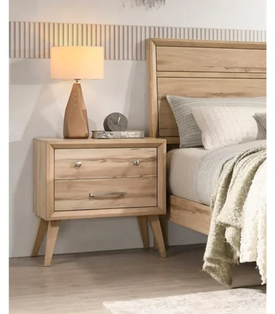 Classic mid-century nightstand with two drawers in natural oak finish, featuring angled legs and lacquered surface.