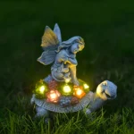 Side view of the solar garden statue, with the angel's wings spread and the turtle's shell detailed in resin.
