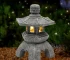 Solar pagoda lantern garden statue with gray stone finish and warm LED glow