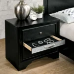 Contemporary black nightstand with hidden drawer and nickel knobs on a bedroom background