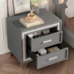 Modern velvet nightstand with silver glitter strip decor and two drawers, placed beside a bed in a bedroom