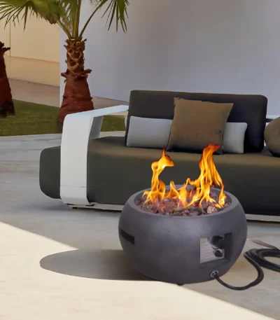 Propane fire pit table with corten steel base and concrete top on a patio