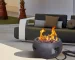 Propane fire pit table with corten steel base and concrete top on a patio