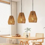 Set of three farmhouse hanging light fixtures with exposed bulbs, ropes hanging from a dark wooden ceiling beam.