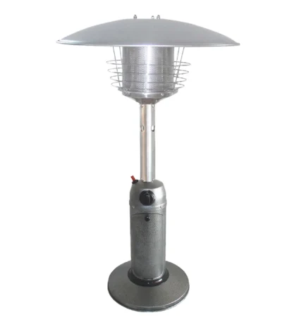 Silver steel propane patio heater on a garden table with soft glow