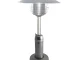 Silver steel propane patio heater on a garden table with soft glow