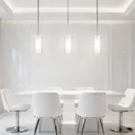 Modern Nordic glass pendant light in black metal, hanging over a wooden dining table.