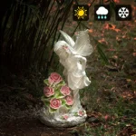 Solar-powered angel figurine illuminated against a dark background with bokeh lights.