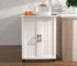 Kitchen island storage cart with barn door and shelves in a modern kitchen