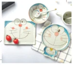 Japanese ceramic dinnerware set with hand-drawn cat design on blue rectangular plate and bowl