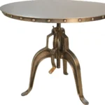 Adjustable height round dining table with antiqued nickel three-leg pedestal base and rivet detailing